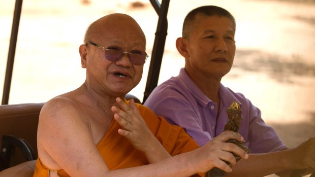 The abbot of the Tiger Temple, Phra Wisutthi Sarathera, is driven past waiting media after authorities found a tiger slaughterhouse. 