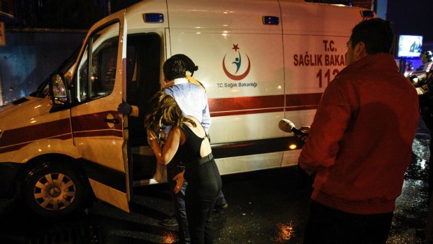 People talk to medics in an ambulance near the scene of an attack in Istanbul.