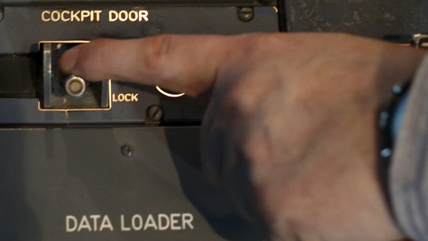 Sealed in: A person moves the switch of the cockpit door locking system inside a flight simulator of an Airbus A320 in Vienna. 