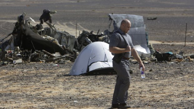 A Russian investigator near plane wreckage in Egypt. 