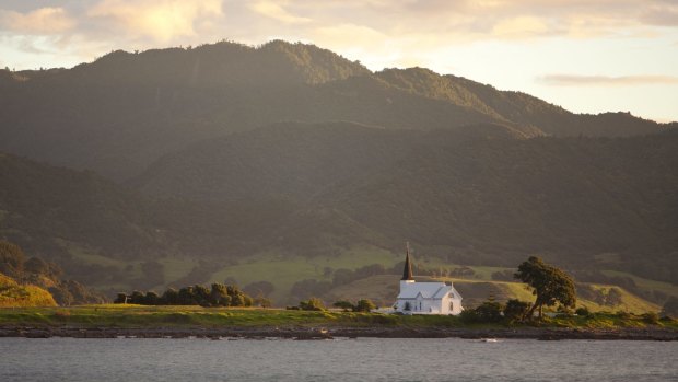 The historic Anglican Christ Church cuts a lonely figure on its promontory in Papatea Bay.