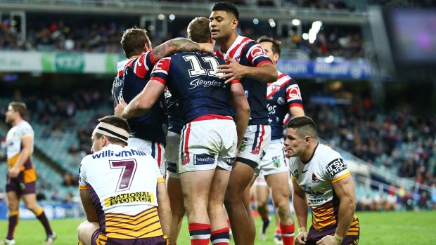 Contrasting fortunes: The Roosters celebrate a Boyd Cordner try.