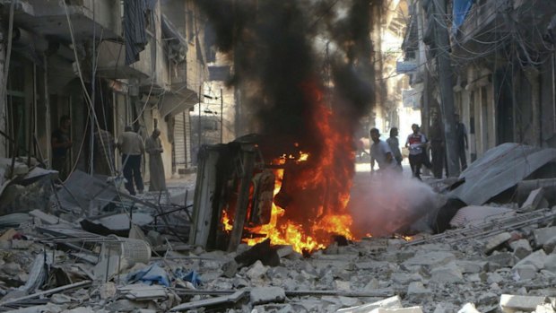 Syrians inspect damaged buildings after air strikes in Mashhad, Aleppo, on Tuesday.