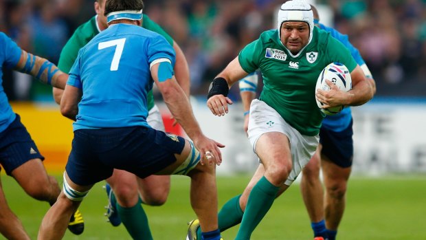 Ireland's Rory Best charges at Simone Favaro of Italy.