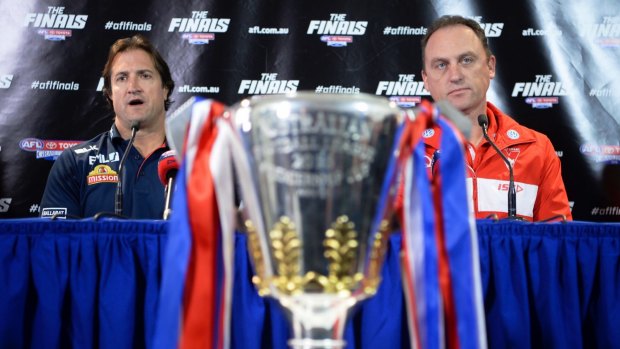 Coaches Luke Beveridge and John Longmire do their best to ignore the object of the ambitions - the AFL cup.
