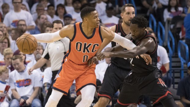 Oklahoma City's Russell Westbrook battles with Houston's Patrick Beverley for the ball.