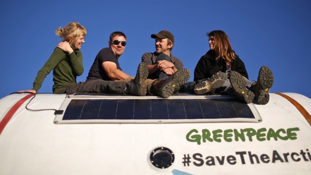 Greenpeace activists sit atop a safety pod on board the Arctic Sunrise.