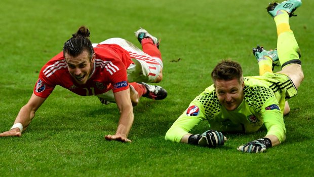 Gareth Bale and Wayne Hennessey celebrate their team's 3-1 win.