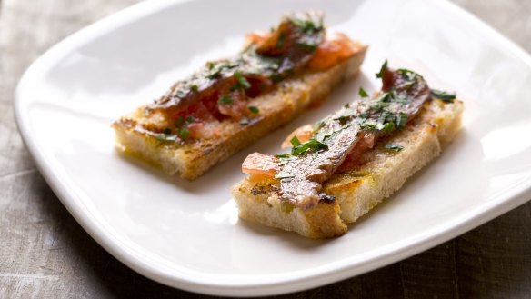 Anchovy with tomato and garlic on grilled bread.