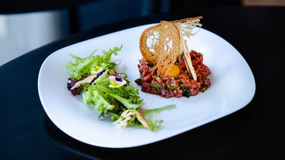 Beef tartare with crostini and salad.