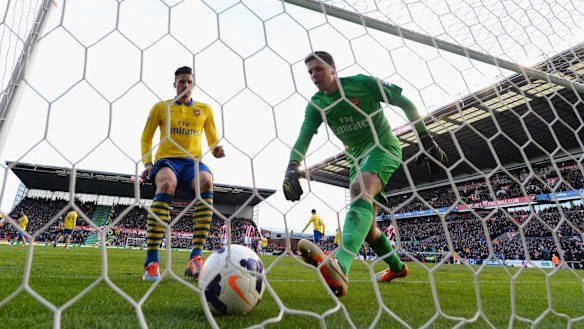 Unlucky break: Wojciech Szczesny collects the ball from the back of the net against Stoke.
