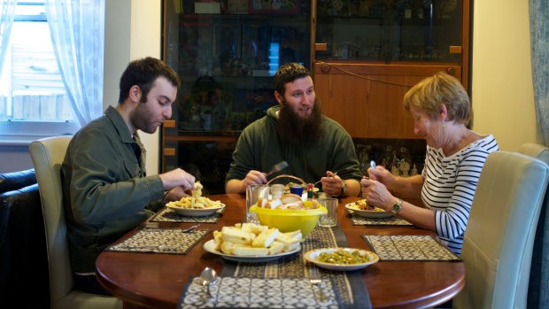 Home for dinner: Musa with his mother, Paula (who still calls him Robert), and one of his brothers, Steven. 