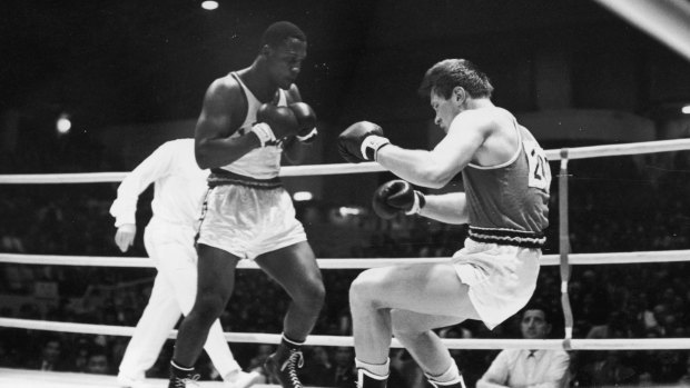 American boxer Joe Frazier fells his Soviet opponent Vadim Yemelyanov in the Olympic Super Heavyweight Boxing semi-final at the Korakuen Ice Palace during the 1964 Tokyo Olympics.