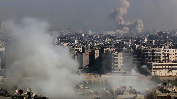 Smoke follows an air strike that hit insurgents positions in eastern Aleppo on Friday.