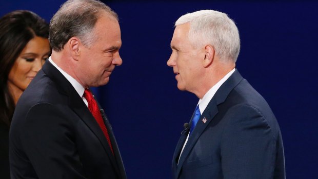 Republican vice-presidential nominee Indiana Governor Mike Pence, right, shakes hands with Democratic vice-presidential nominee Senator Tim Kaine.