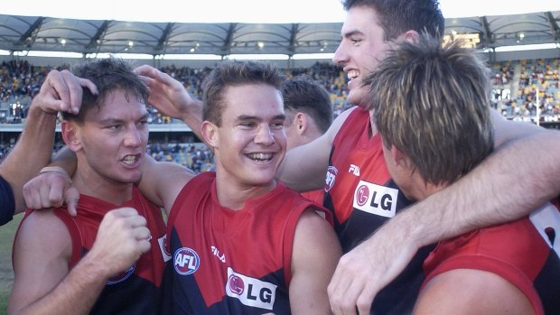 BRISBANE - JULY 7:  Melbourne players celebrate winning against Brisbane during the AFL round 14 match played between the Brisbane Lions and the Melbourne Demons at the Gabba in Brisbane, Australia on July 7, 2002.  (Photo by Darren England/Getty Images).