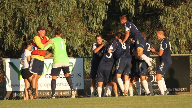 Players from Knox City celebrate a goal against Pascoe Vale in the FFA Cup.