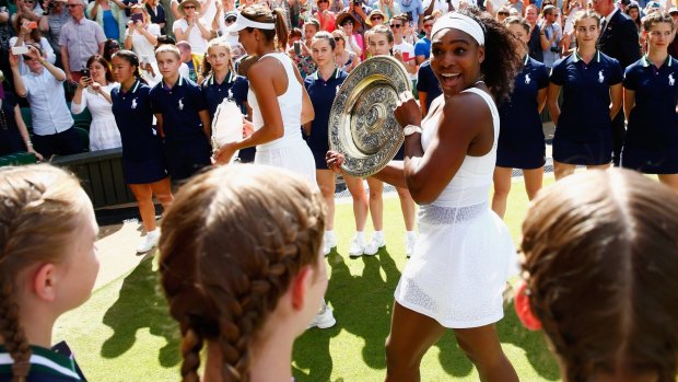 A delighted Serena Williams leaves court with the Venus Rosewater Dish after her Wimbledon victory.