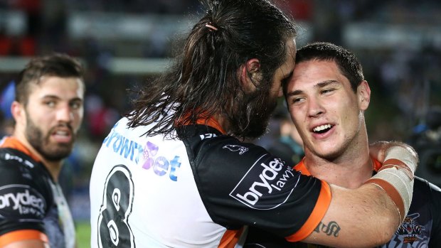Still part of the team: Aaron Woods congratulates Mitchell Moses after full-time against the Cowboys.