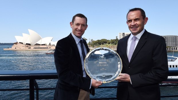 Winx's Jockey Hugh Bowman (left) and trainer Chris Waller with the Cox Plate.