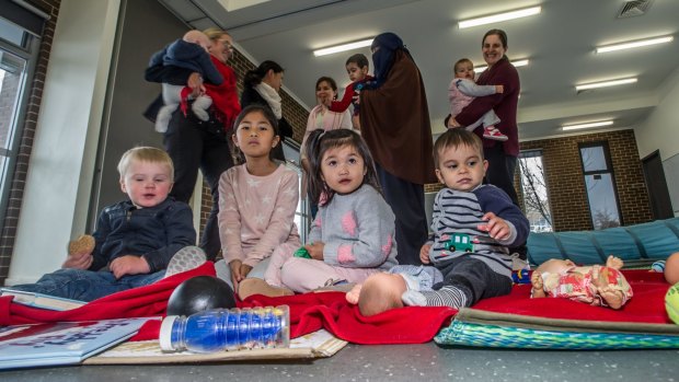 Gungahlin now has 71,000 souls, including those at the mothers club playgroup at the Forde community centre. Photo by Karleen Minney. (front from left) Thomas McPherson, 21 months, Mya Chan, 3, and Jada Chan, 6 and Mosesz Tahmbaya, 13 months. (back from left) Karen McPherson (holding Samuel, 4 months), Amy Chan, Felicity Thambyah, Ruqayah Jabi (holding Salah, 2,) and Melanie Pollack (holding Scarlett, 19 months)