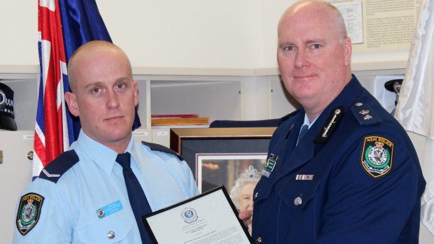 Christopher Sheehy (left) receives a bravery award from Newtown Police Commander Simon Hardman in September 2015. The young officer was being covertly monitored during the same period on the  recommendation of his boss. 