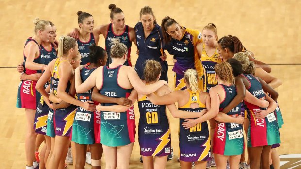 Lightning and Vixens players form a huddle after the Super Netball major semi-final.