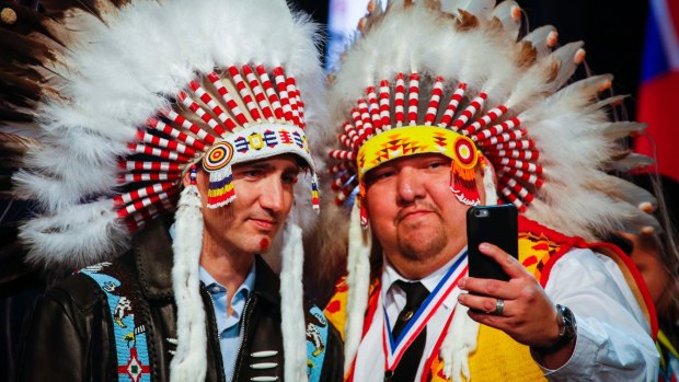 Canadian Prime Minister Justin Trudeau poses for a selfie with an elder after receiving a ceremonial headdress while visiting the Tsuut'ina First Nation near Calgary last year. 