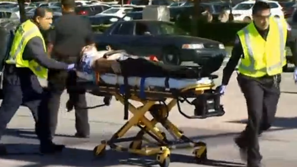 A victim of the shooting is taken away by paramedics.