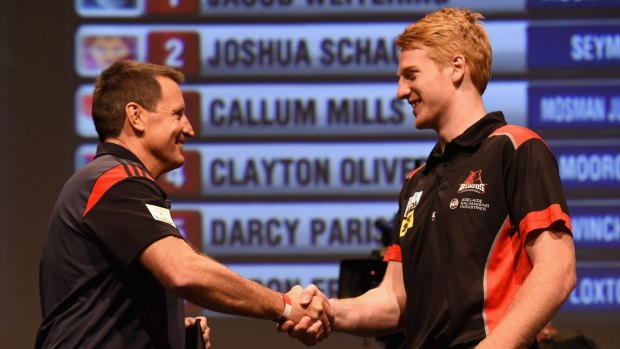 Essendon coach John Worsfold shakes hands with Aaron Francis.