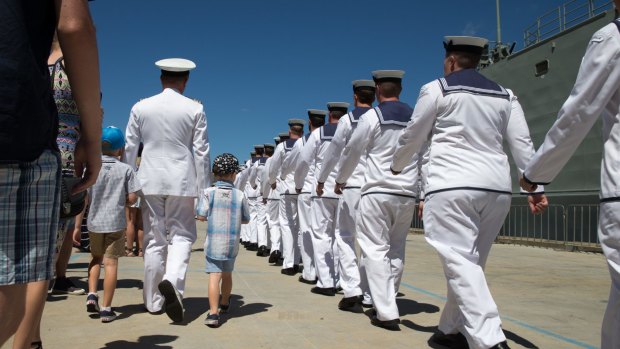 Commander Phillip Henry's family escort him to the gangway before he leaves for the seven-month tour on HMAS Darwin. 