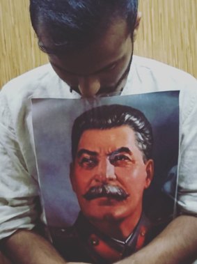 Jay Tharappel, a protege of Tim Anderson at the University of Sydney, with a picture of Soviet dictator Joseph Stalin.