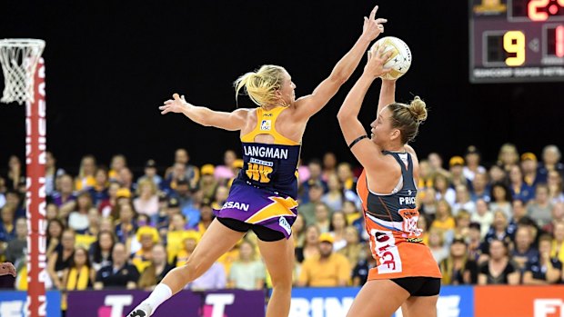 The Giants' Jamie-Lee Price is pressured by the defence of Laura Langman.