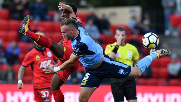 Just for kicks: Mark Ochieng and Sydney FC’s Jordy Buijs take a swing for the ball. 