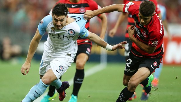 Season slipping from their grasp: Wanderers defender Jonathan Aspropotamitis holds on to Bruno Fornaroli in Friday night's defeat.