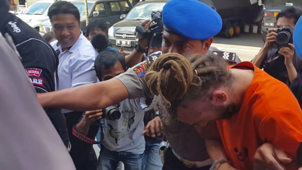 David Taylor taken from his holding cell at Denpasar police station for interrogation.