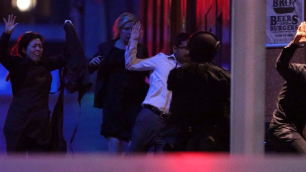 Hostages flee after police raided the Lindt cafe.