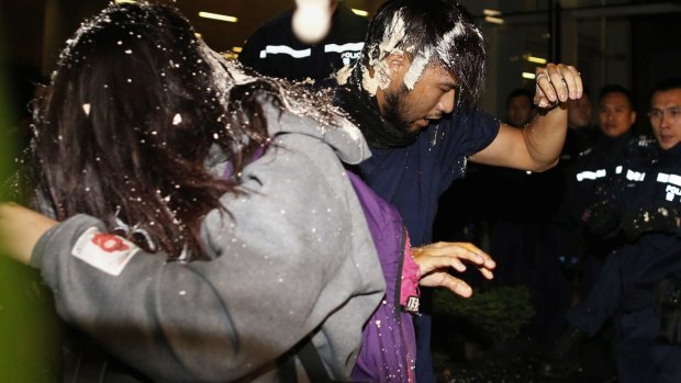 Barred: Police fight back against pro-democracy protesters as they try to break into the Legislative Council.