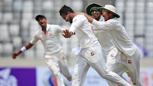Jubilation: Teammates congratulate Bangladesh's Shakib Al Hasan after the dismissal of Glenn Maxwell.
