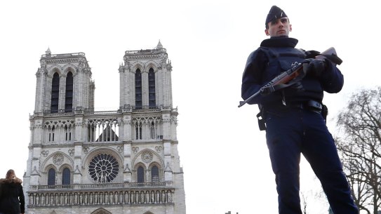 A French police officer stands guard outside Notre Dame cathedral in Paris earlier this year.