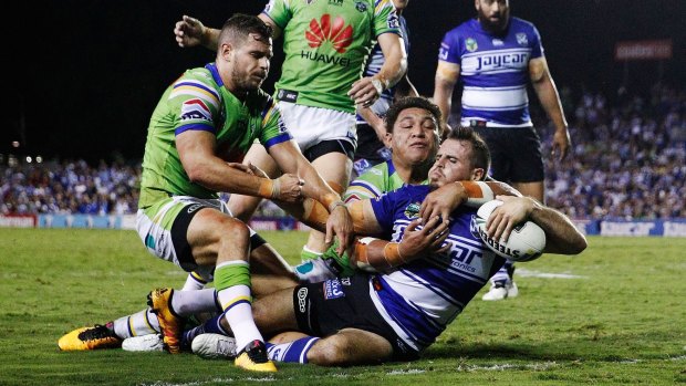 Aidan Sezer tries to stop Josh Reynolds of the Bulldogs from scoring a try.