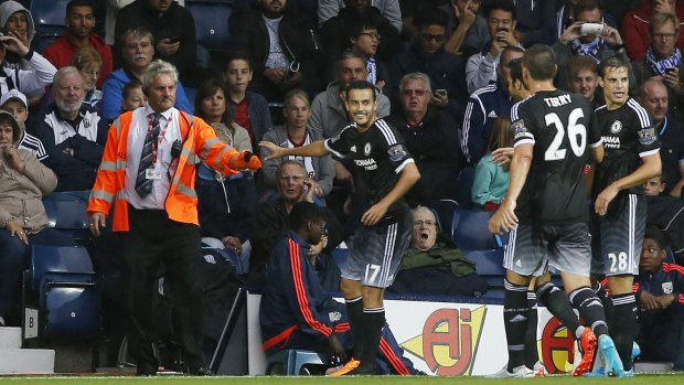 Debut delight: Pedro celebrates with Jose Mourinho after scoring his first goal for Chelsea.