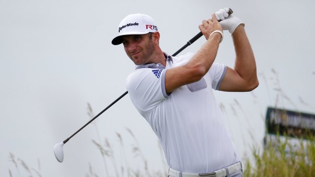 Dustin Johnson of the United States watches his tee shot on the 13th.