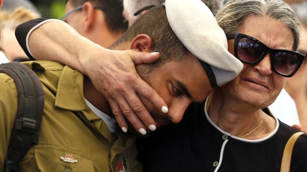 A comrade of 20-year-old Israeli army Staff Sergeant Amit Yeori mourns during his funeral at the Mount Herzl military cemetery in Jerusalem on Sunday.