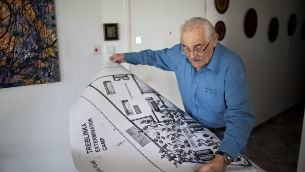 In this 2010 photo, Holocaust survivor Samuel Willenberg displays a map of Treblinka extermination camp.