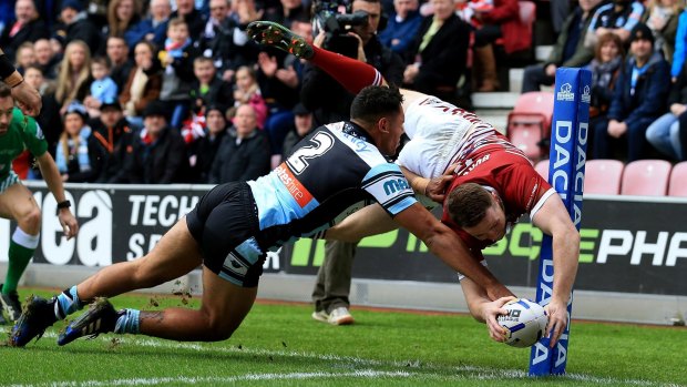 Spectacular: Joe Burgess scores the opening try for Wigan.