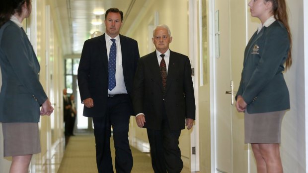 Philip Ruddock (right) departs Monday's Liberal party room meeting to announce the result.