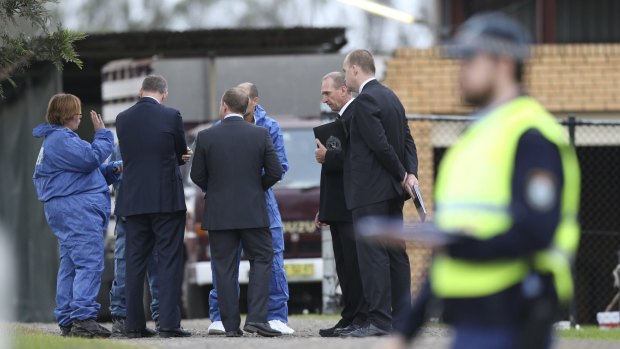 Detectives at the scene of the Badgerys Creek home invasion.
