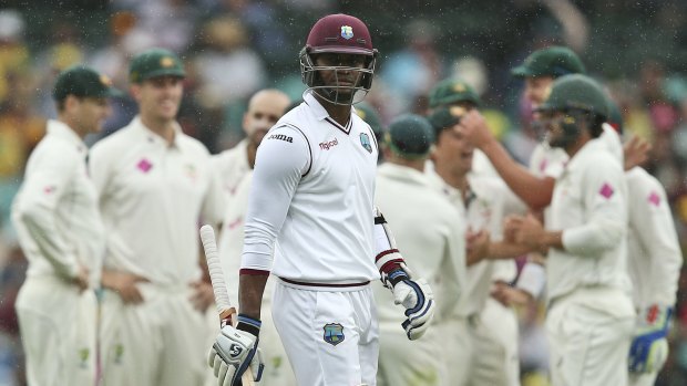 Luck runs out: Marlon Samuels walks past the delighted Australians after his disastrous departure.
