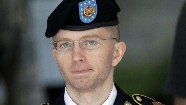 Former Army Pfc. Bradley Manning is escorted out of a courthouse in Fort Meade, Maryland in 2013.
